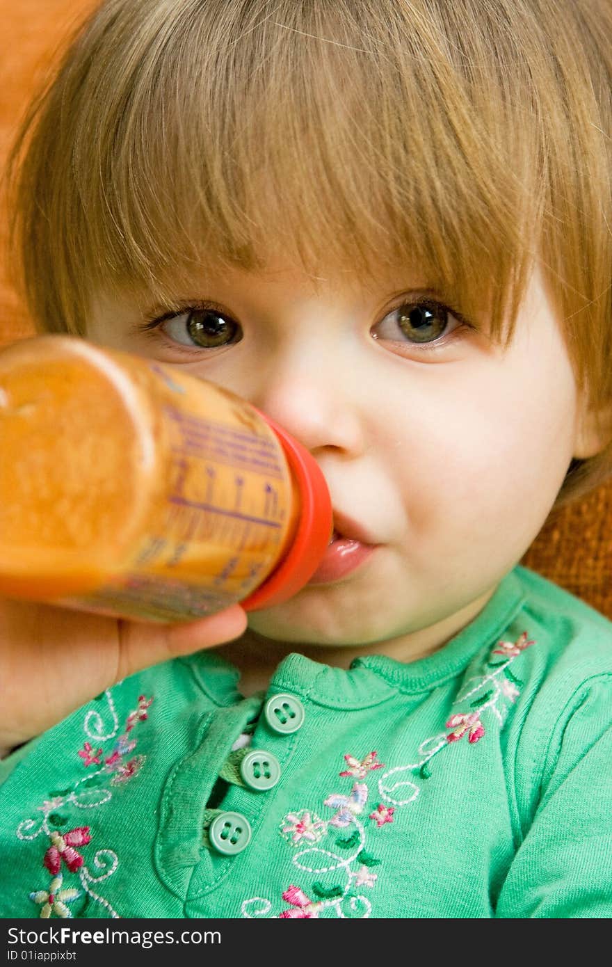 Sweet baby girl drinking on sofa. Sweet baby girl drinking on sofa