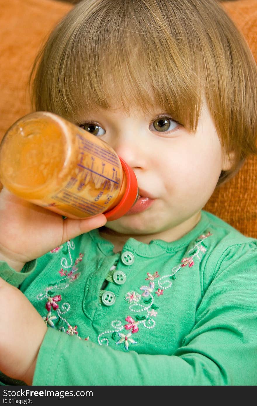 Sweet baby girl drinking on sofa. Sweet baby girl drinking on sofa