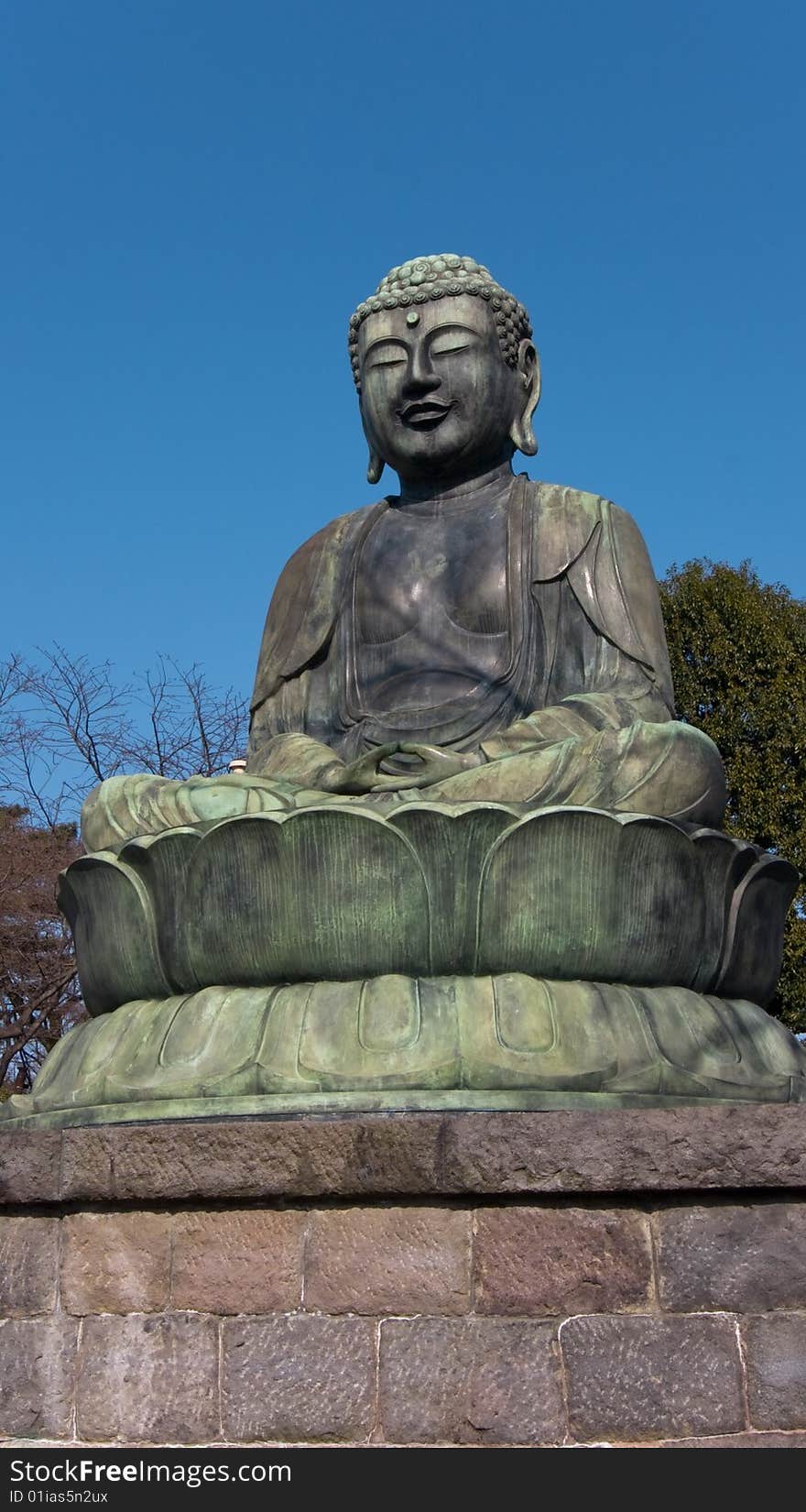 View on a sitting Buddha statue in Ikebukuro, Tokyo, Japan