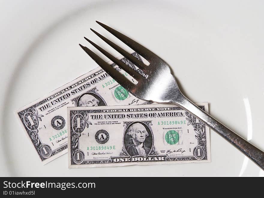 Shrunken dollars on white plate with a fork. Shrunken dollars on white plate with a fork.