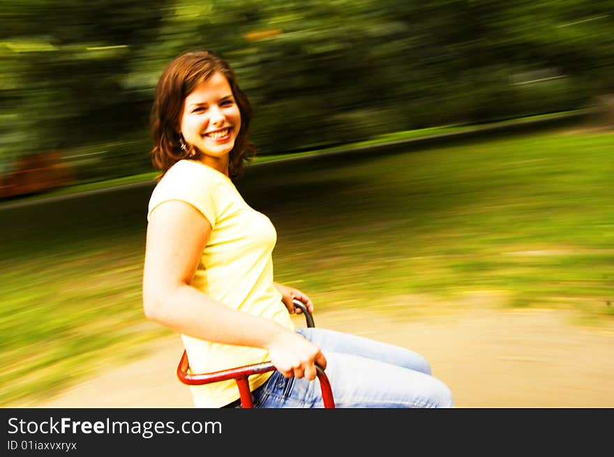 Young girl having fun on roundabout