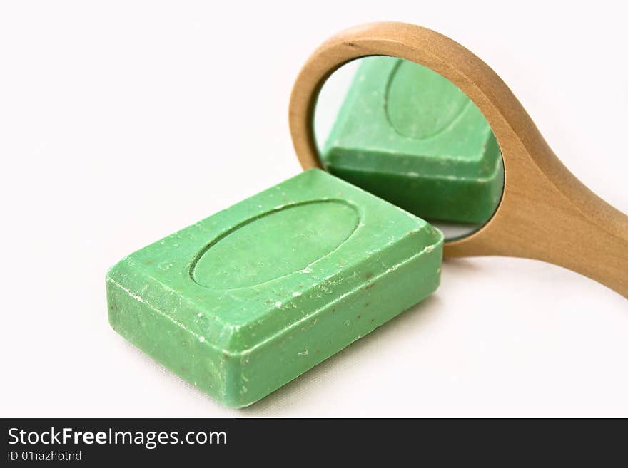 Green Soap reflecting on a mirror on white background