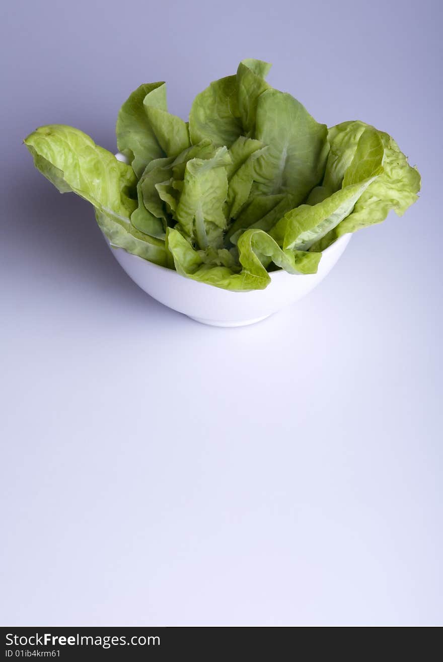 Green salad in white bowl