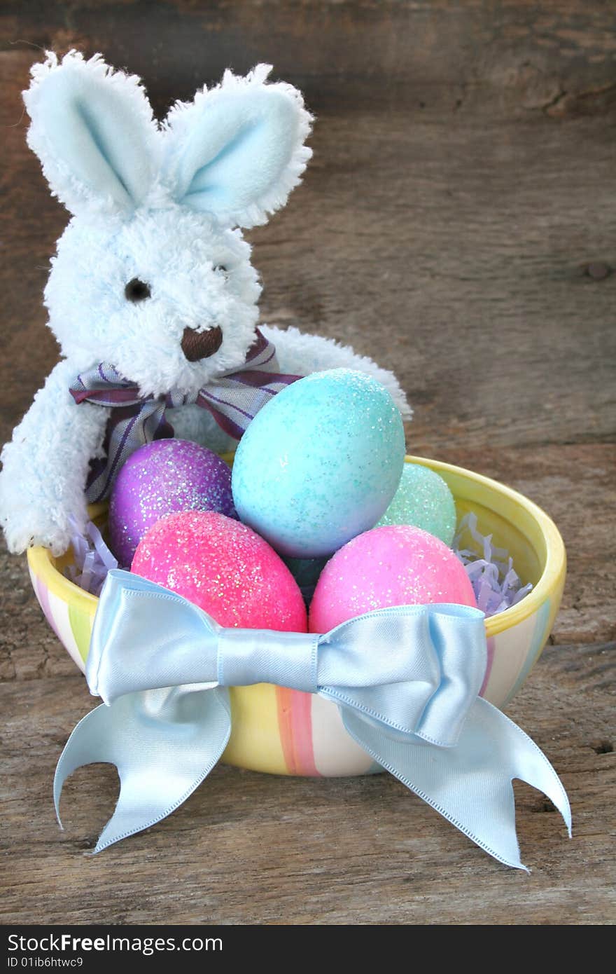 Stuffed Easter bunny with Easter eggs and a pretty blue bow. Stuffed Easter bunny with Easter eggs and a pretty blue bow.