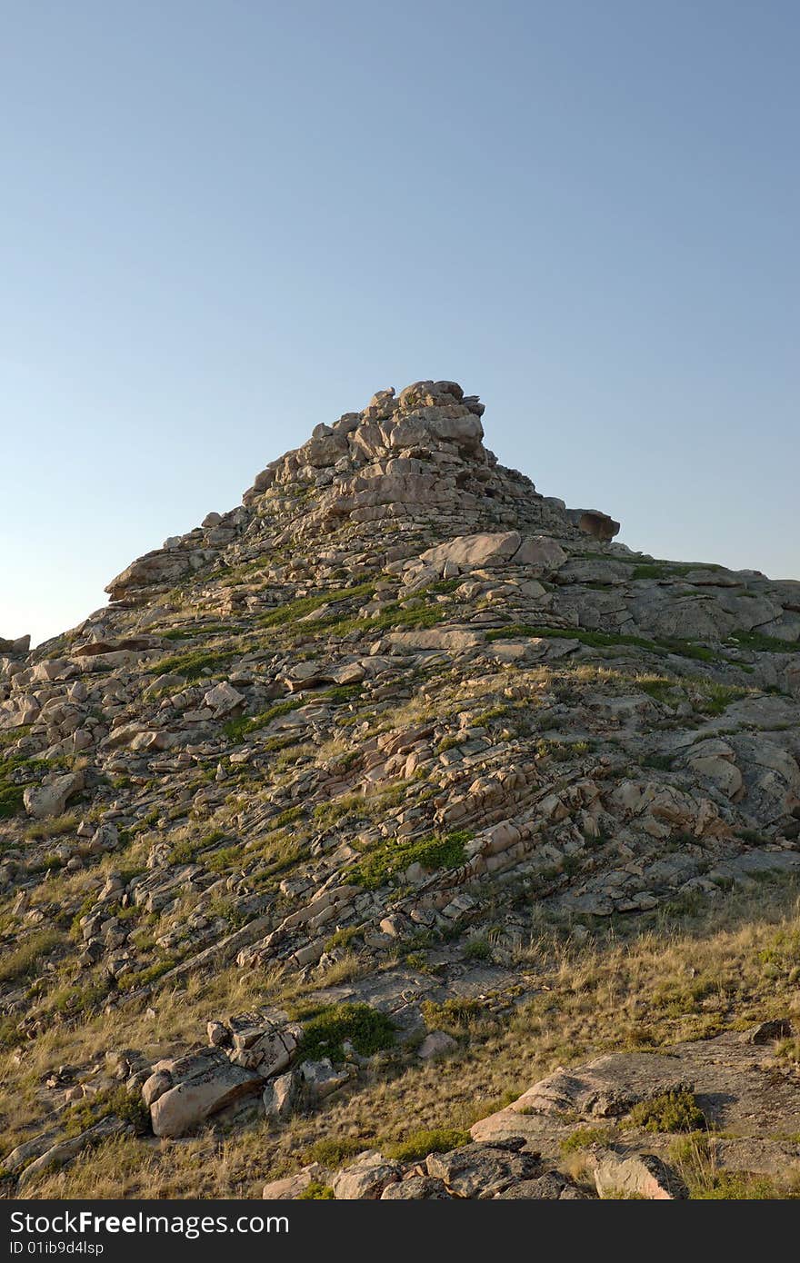 Mountain with rocks under blue sky