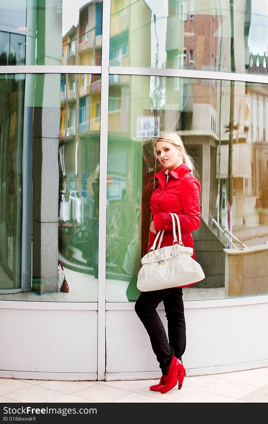 Beautiful young woman in red coat and boots. Beautiful young woman in red coat and boots