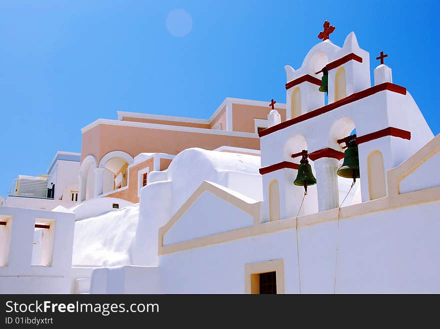 Church on Santorini Island - Oia - Greece. Blue sky, white church and  bells tower. Church on Santorini Island - Oia - Greece. Blue sky, white church and  bells tower.