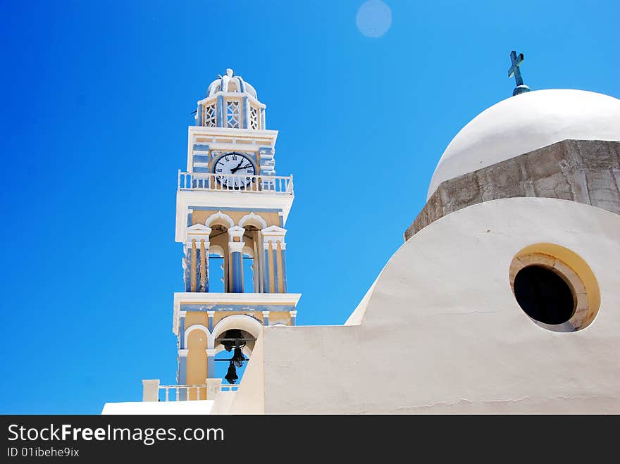 Church on Santorini Island, Thira - Greece. Blue sky, clock tower and white church. Super last minute Fostertravel.pl. Church on Santorini Island, Thira - Greece. Blue sky, clock tower and white church. Super last minute Fostertravel.pl