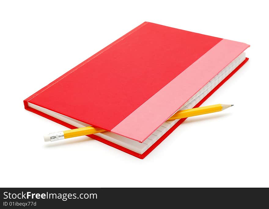 Red notebook with pencil over white background