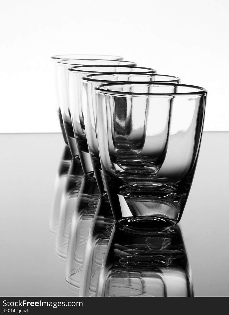 Set of the liquor-glasses on glass surface