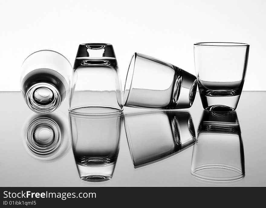 Set of the liquor-glasses on glass surface