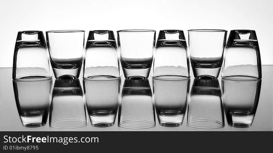 Set of the liquor-glasses on glass surface