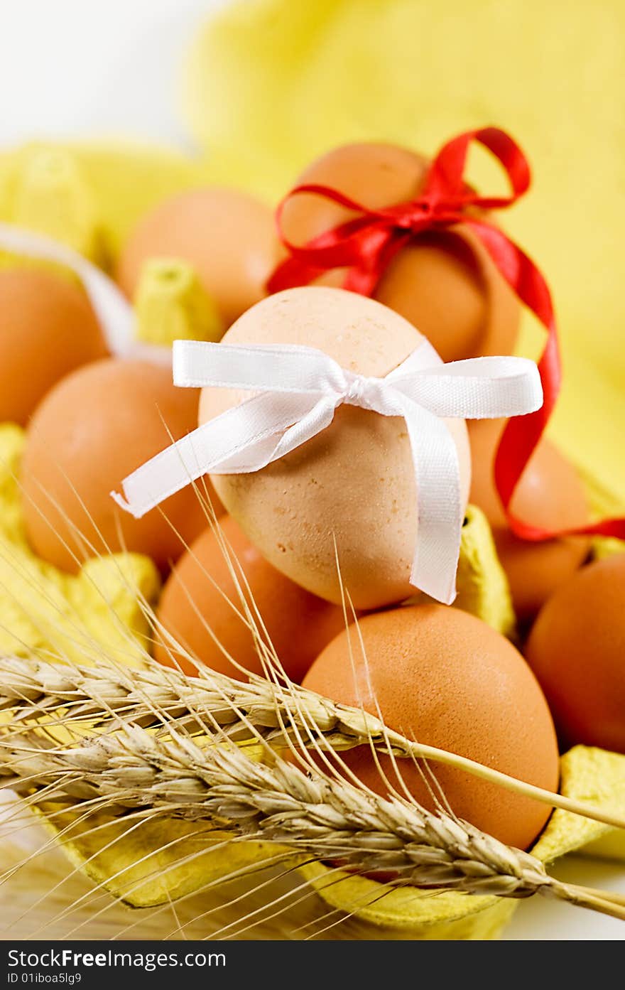 Eggs with red and white baw and wheat, easter concept. Eggs with red and white baw and wheat, easter concept