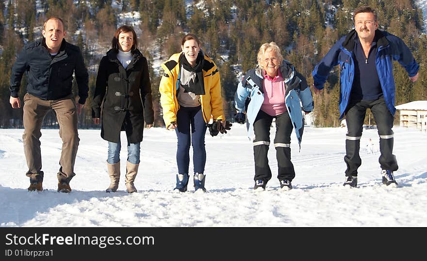 Family in a and outdoor winter setting. Jumping in joy! Slight motion bluriness is intended. Family in a and outdoor winter setting. Jumping in joy! Slight motion bluriness is intended.