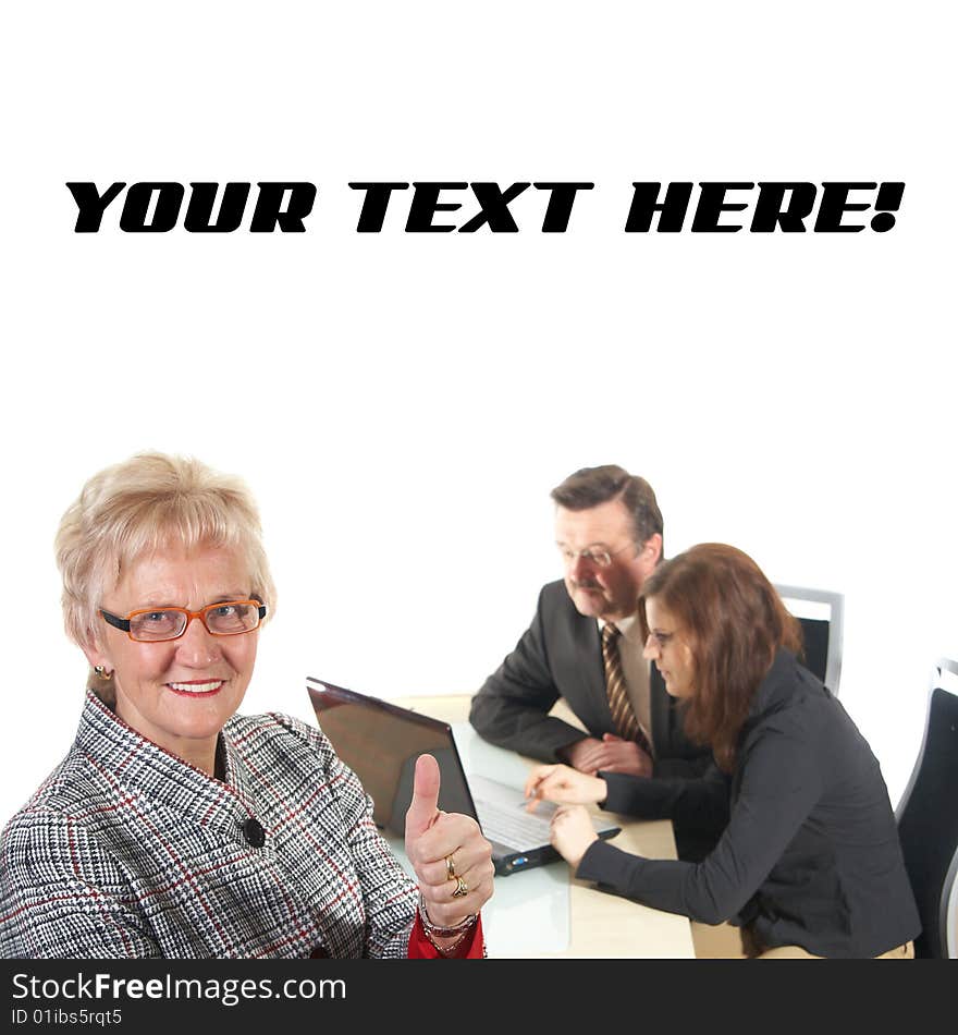 Businesswoman showing tumb up sign in office environment. Three people with focus on mature woman in front. Isolated over white. Businesswoman showing tumb up sign in office environment. Three people with focus on mature woman in front. Isolated over white.