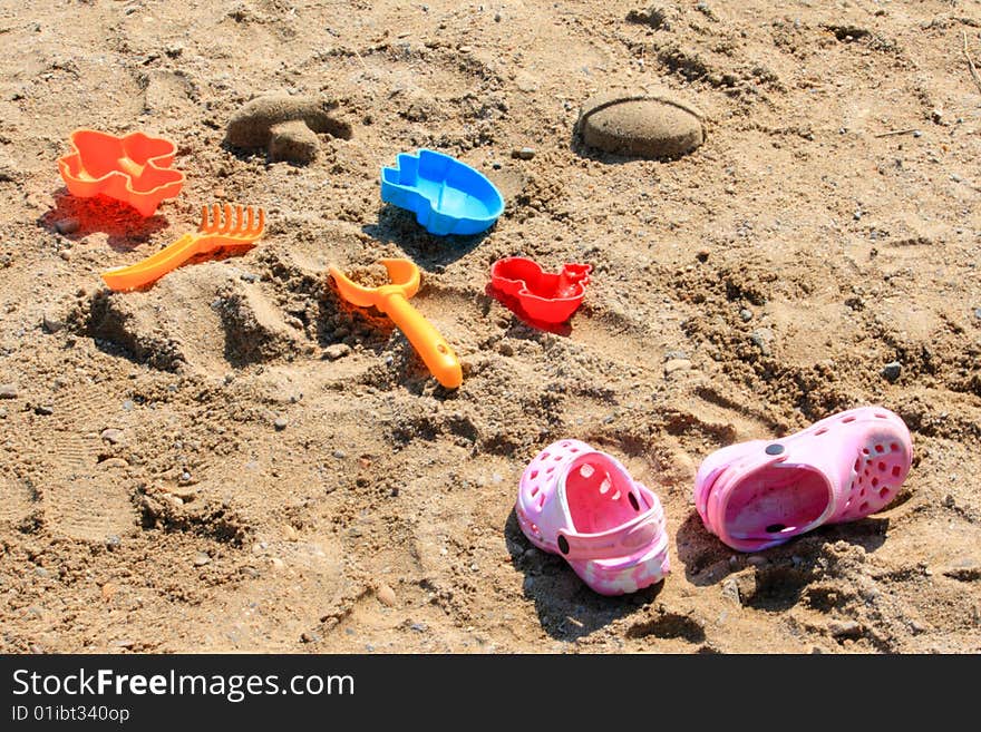 Plastic colorful beach toys on sand