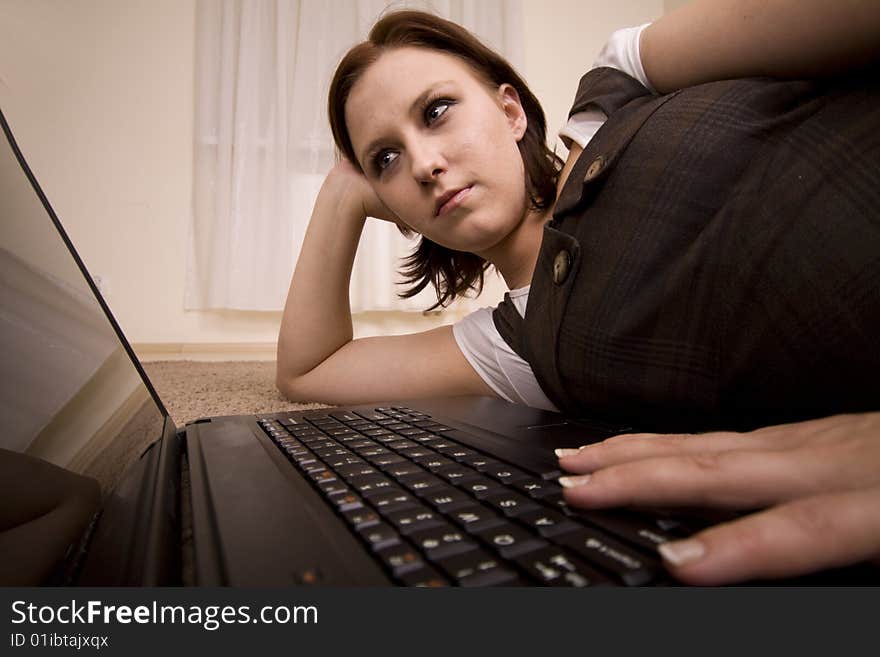 Woman with laptop on carpet