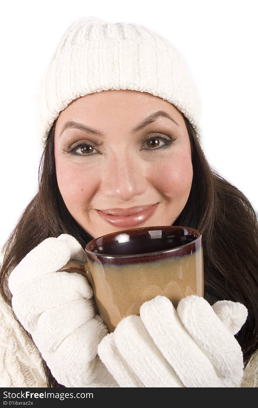 A pretty asian woman drinks a hot beverage in winter clothes. A pretty asian woman drinks a hot beverage in winter clothes