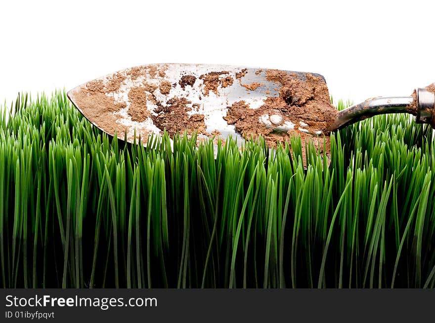 Dirty garden spade on grass