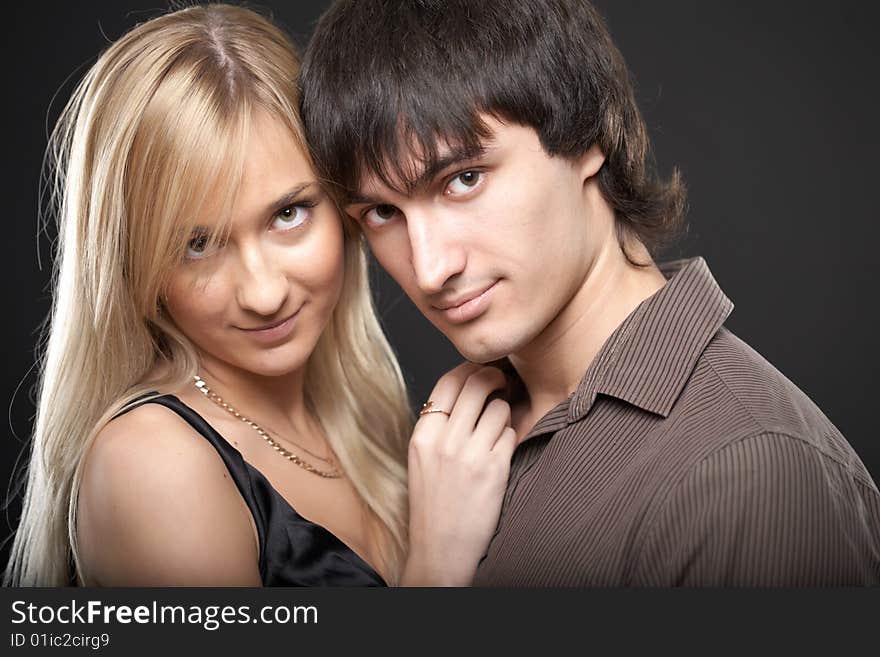 Young couple man and woman on black background