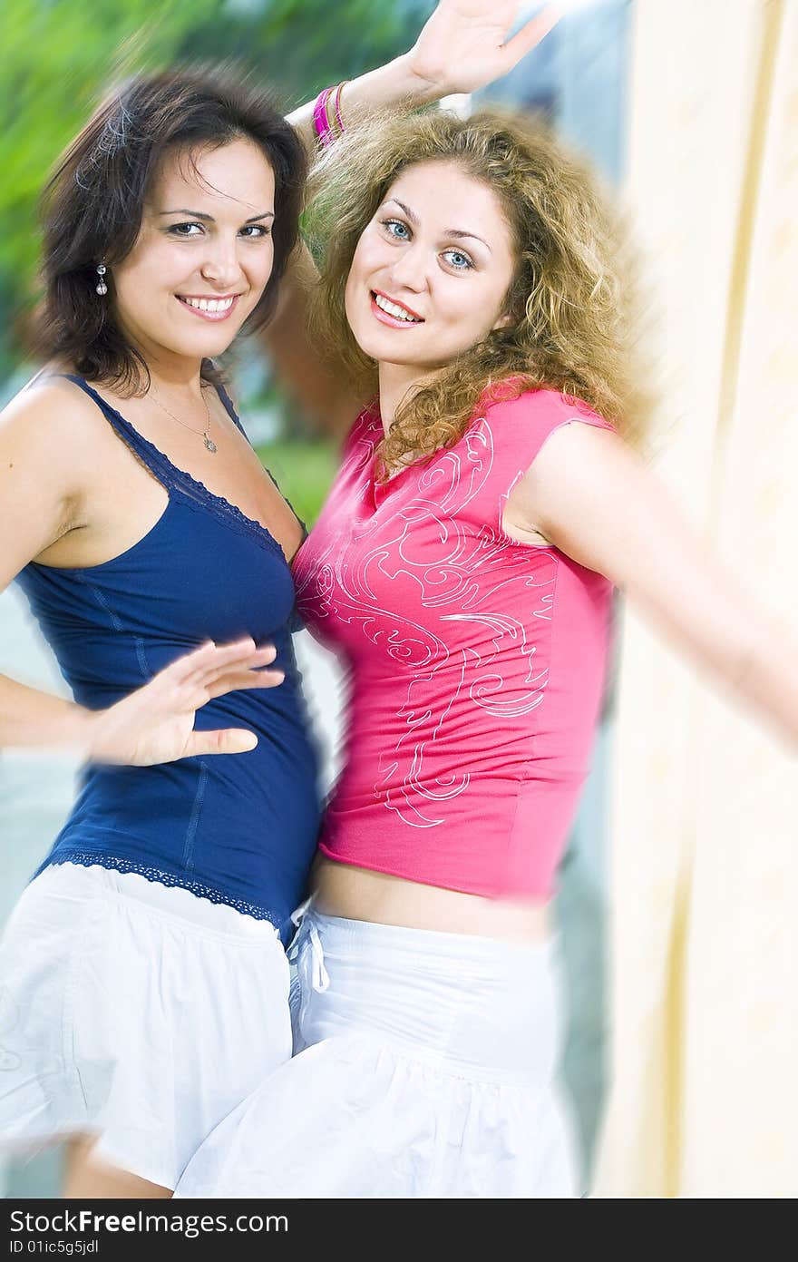 Portrait of two young happy girls having good time. Portrait of two young happy girls having good time