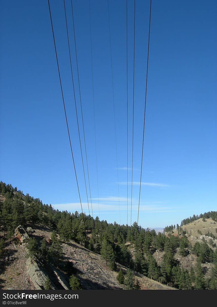 Power lines fade into the hillside. Power lines fade into the hillside