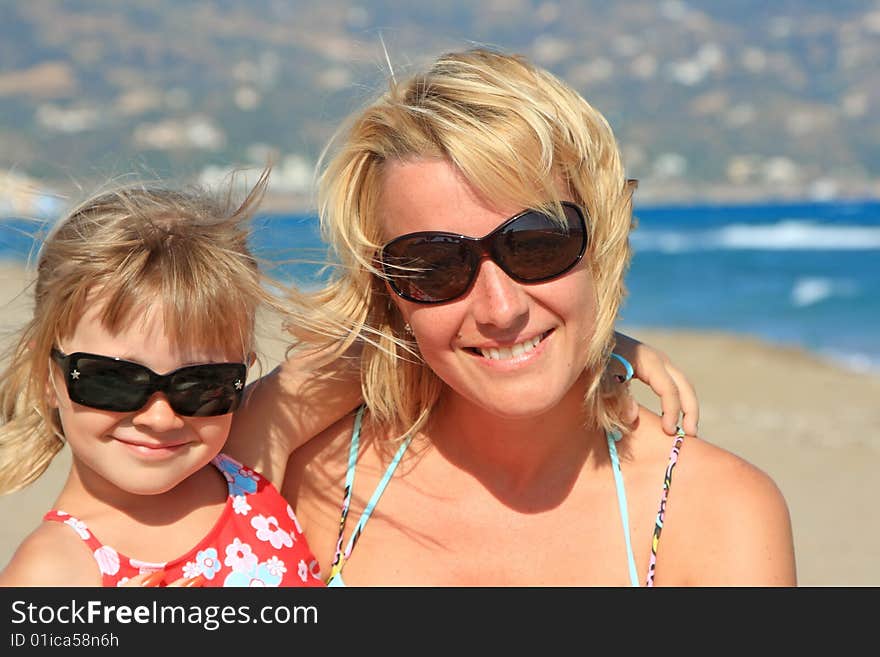 Happy mum with a daughter have a rest on the sea