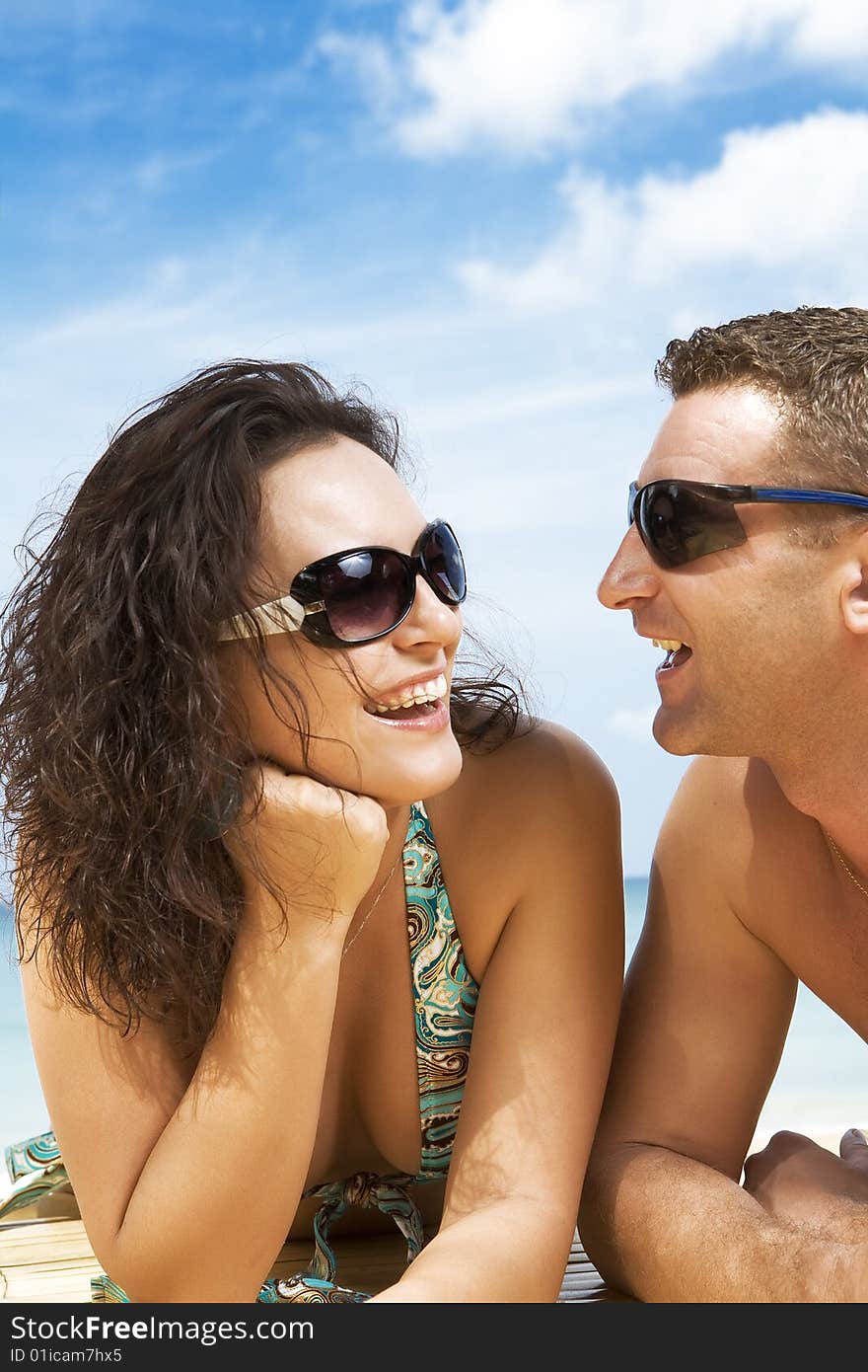 A portrait of attractive couple having fun on the beach. A portrait of attractive couple having fun on the beach.