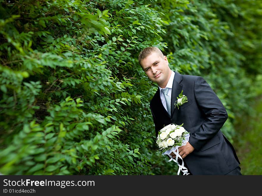 A groom looking at watch. A groom looking at watch