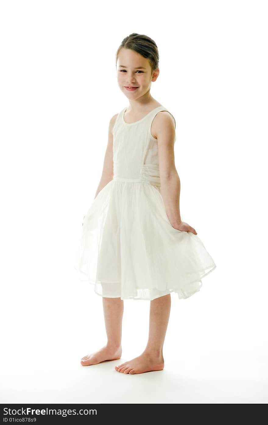 Little girl smiling in camera isolated on white background. Showing an elegant white dress. Little girl smiling in camera isolated on white background. Showing an elegant white dress.