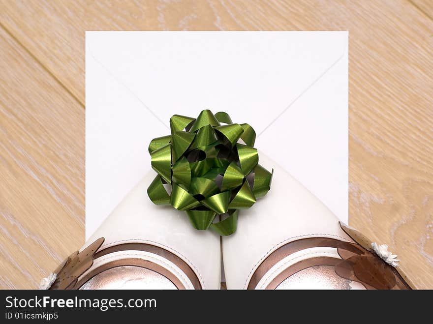 An envelope with a letter and a green bow left behind by the white shoes. An envelope with a letter and a green bow left behind by the white shoes