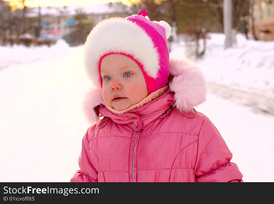 Pretty little girl in winter outerwear - outdoor portrait. Pretty little girl in winter outerwear - outdoor portrait.