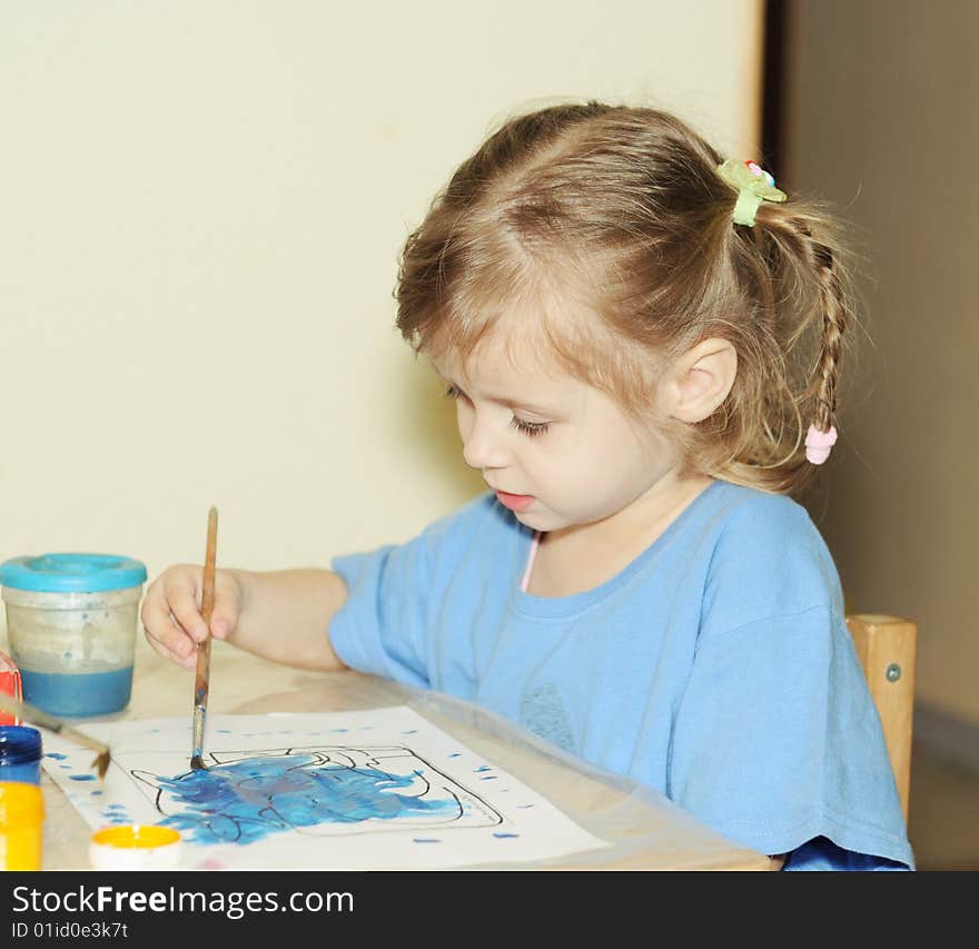 Toddler girl draws by paint. Toddler girl draws by paint