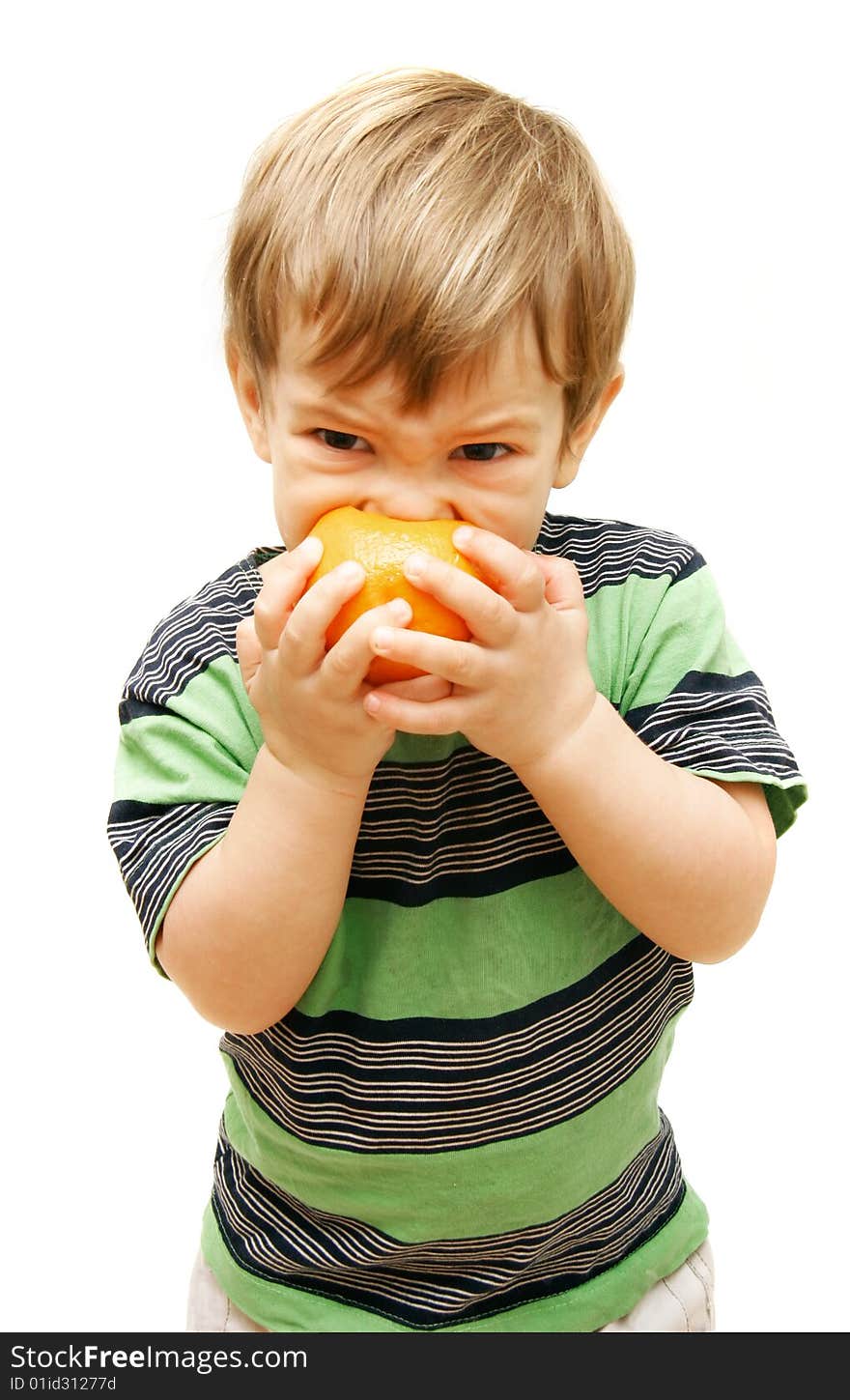 Boy eating orange over white