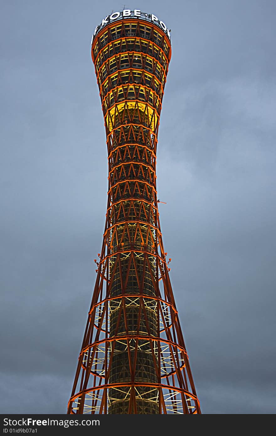 Evening time view of the red port tower surrounded by blue sky near the harbor area in Kobe city, Japan. Evening time view of the red port tower surrounded by blue sky near the harbor area in Kobe city, Japan