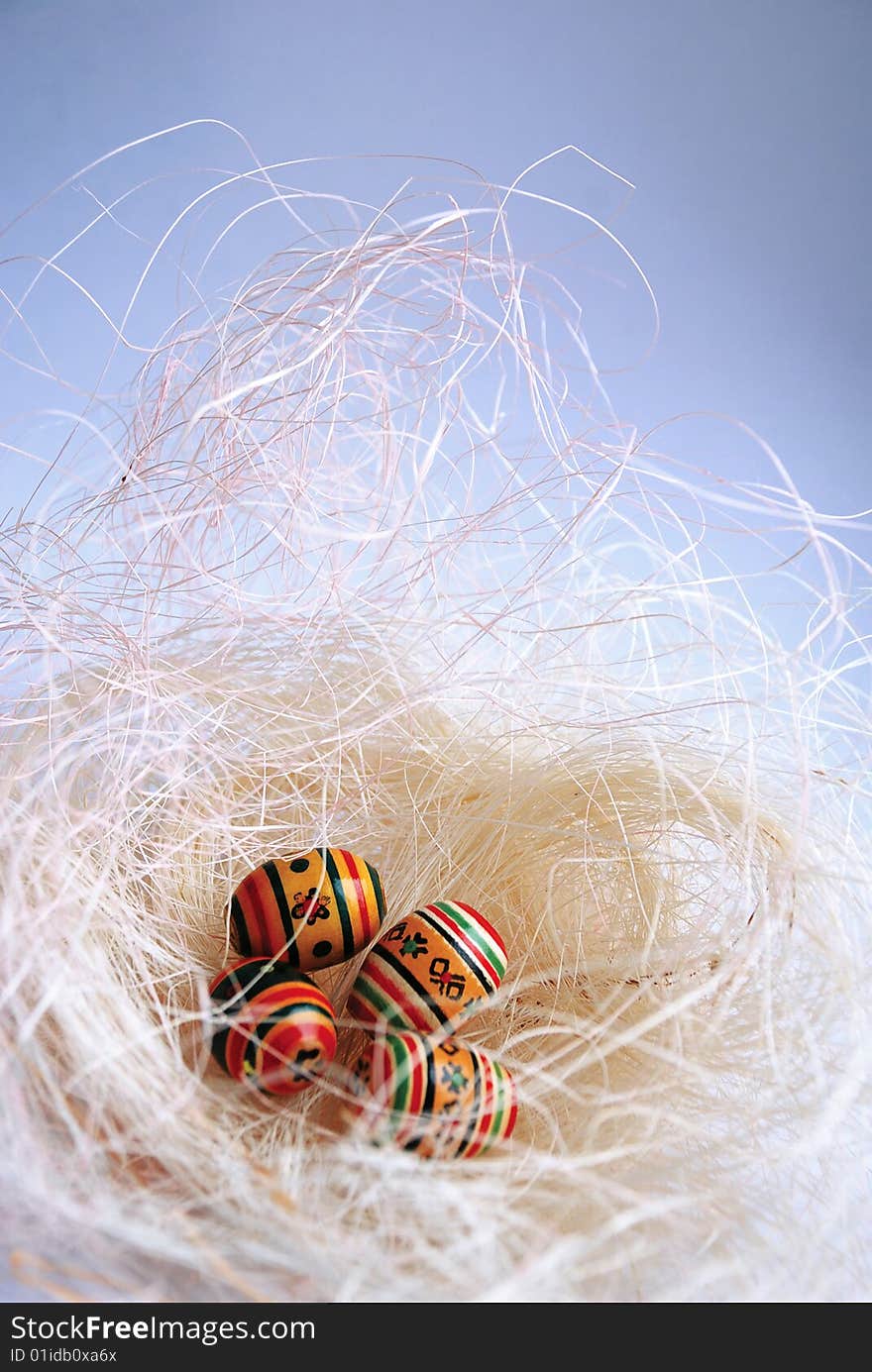 Decorative eggs are in a nest, easter still life, From above enough available space is for inscriptions