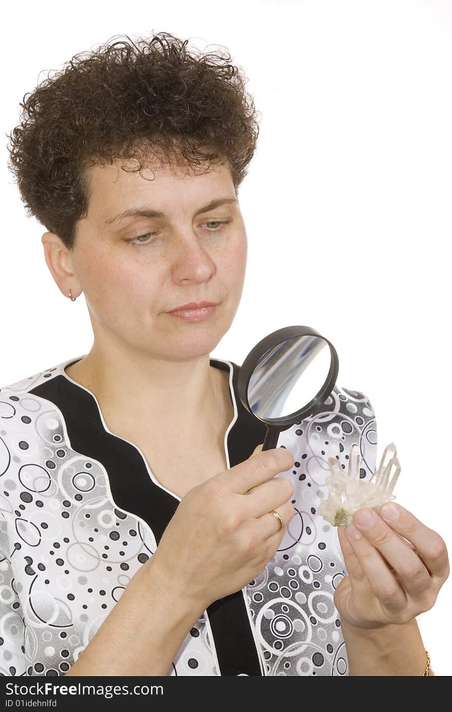 Curly woman with magnifying glass and stone on white background