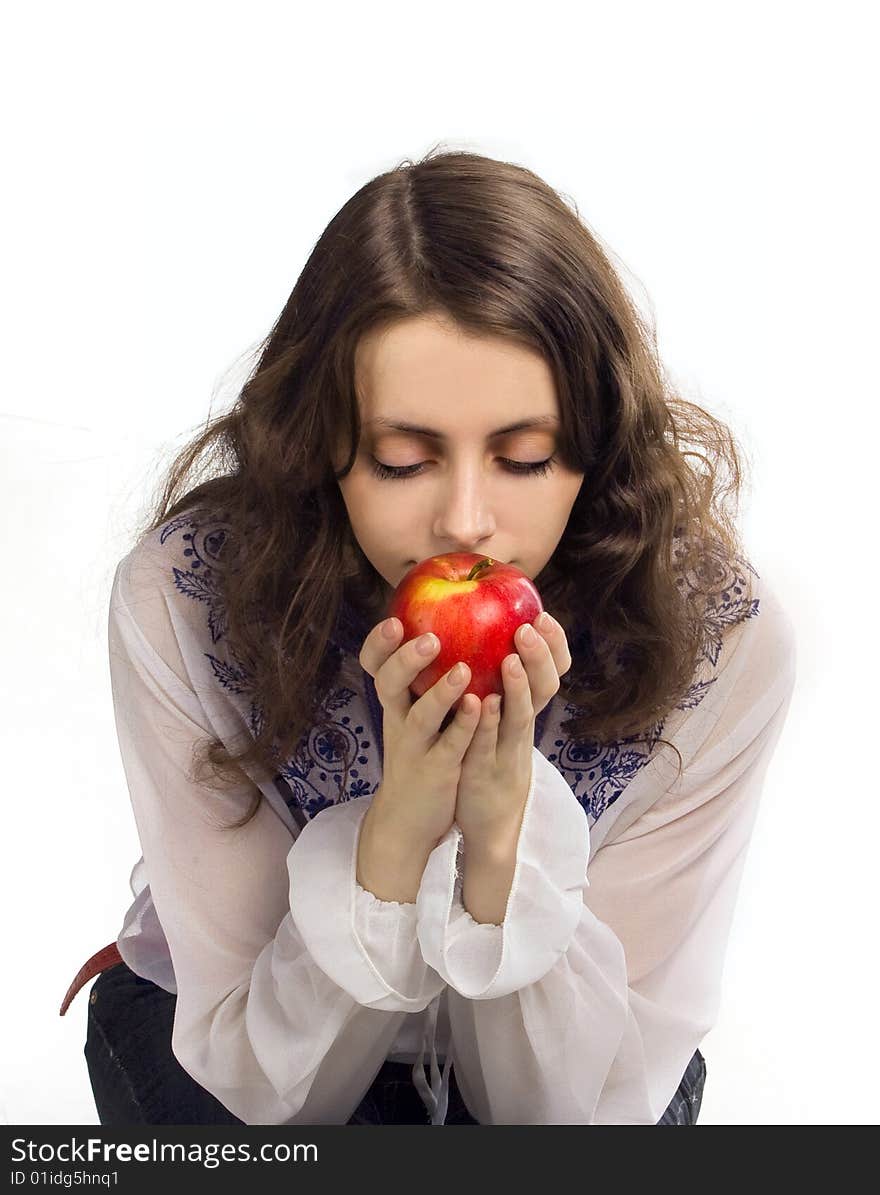 Young beautiful girl enjoys the aroma of apple. Young beautiful girl enjoys the aroma of apple