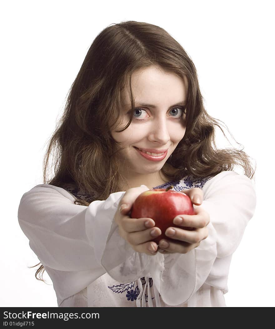 Young beautiful girl stretches out you a red apple. Young beautiful girl stretches out you a red apple