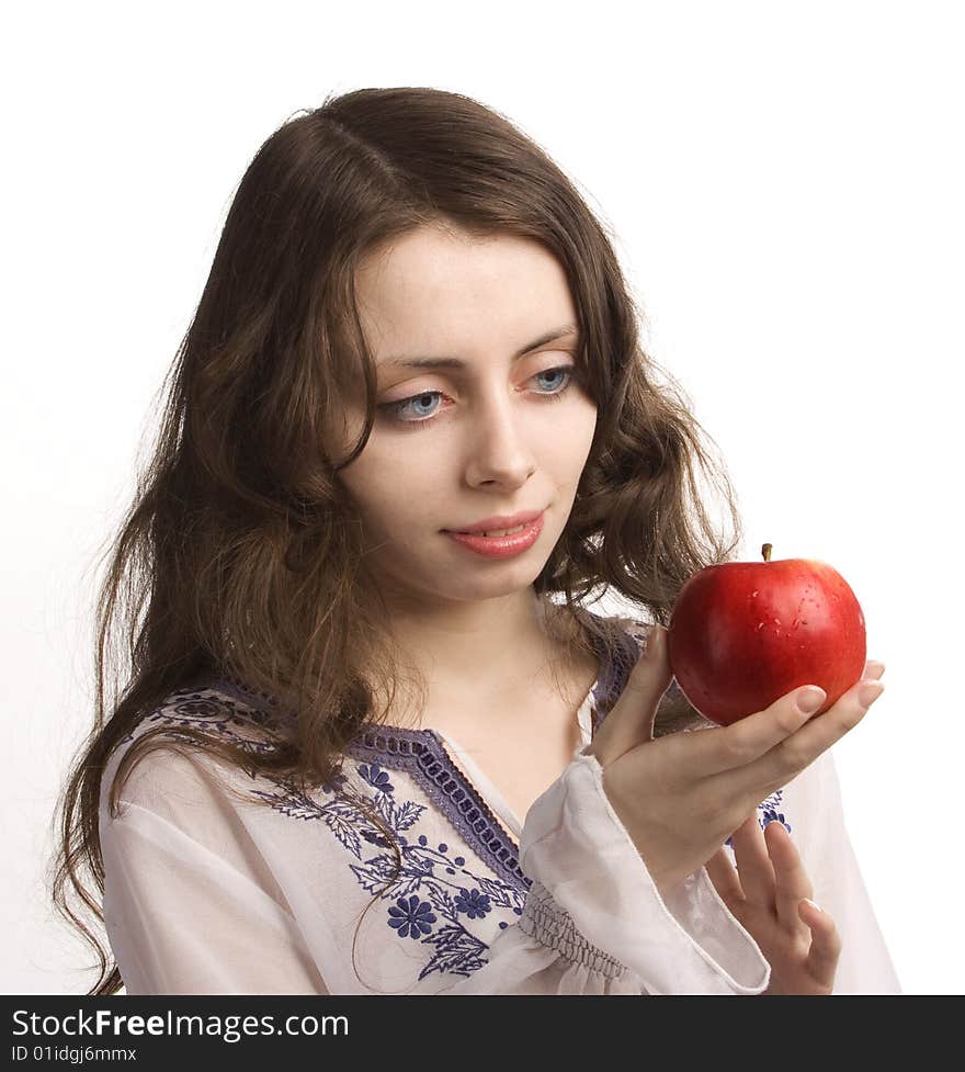 Young beautiful girl stretches out you a red apple. Young beautiful girl stretches out you a red apple