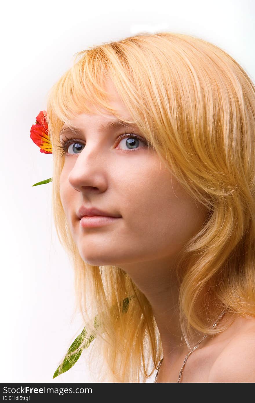 Young beautiful girl blonde with a flower in hairs. Young beautiful girl blonde with a flower in hairs