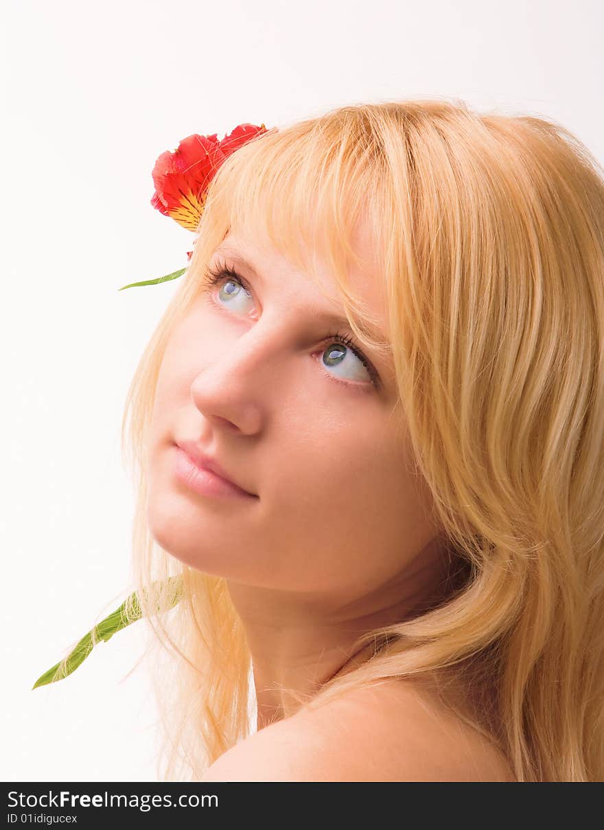 Young beautiful girl blonde with a flower in hairs. Young beautiful girl blonde with a flower in hairs