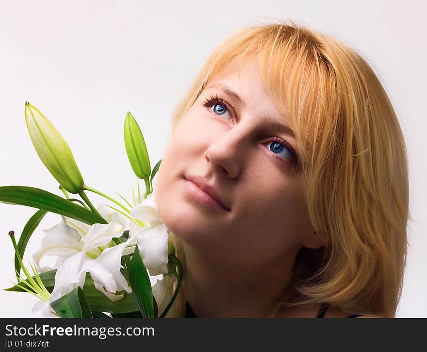 Beautiful young woman a blonde with lily flower. Beautiful young woman a blonde with lily flower