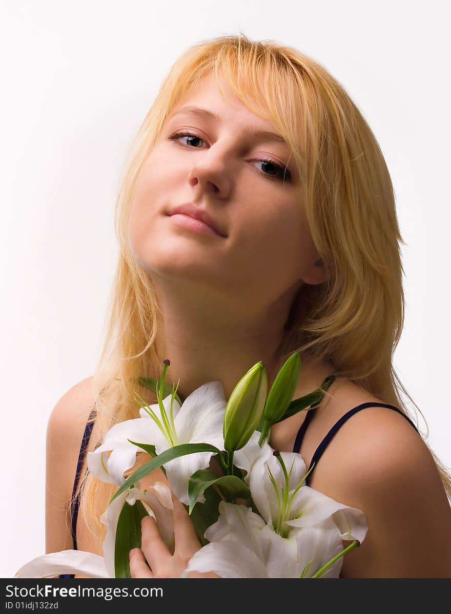 Beautiful young woman a blonde with lily flower. Beautiful young woman a blonde with lily flower