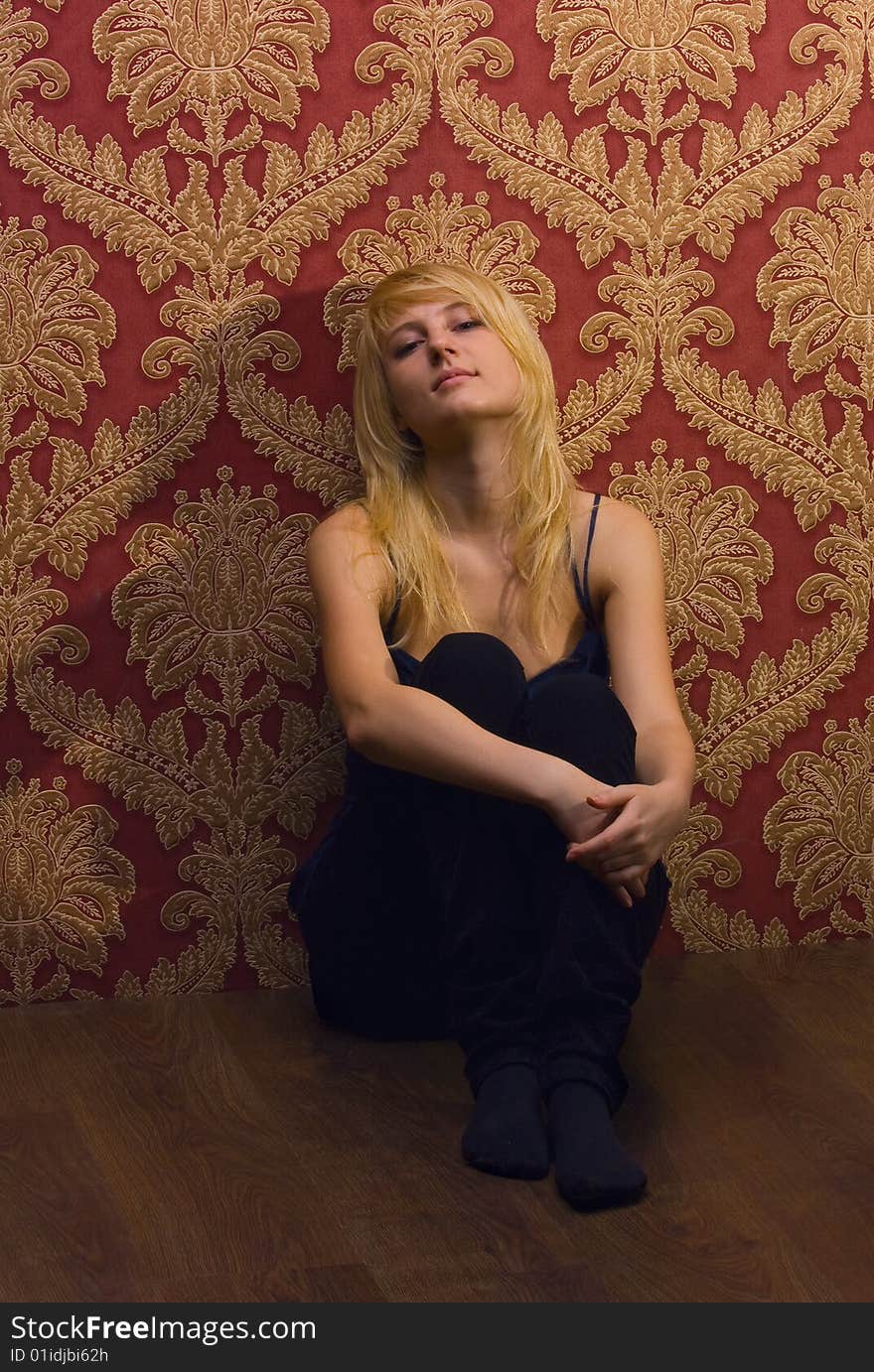 A Young Woman Leaning Against A Wall.