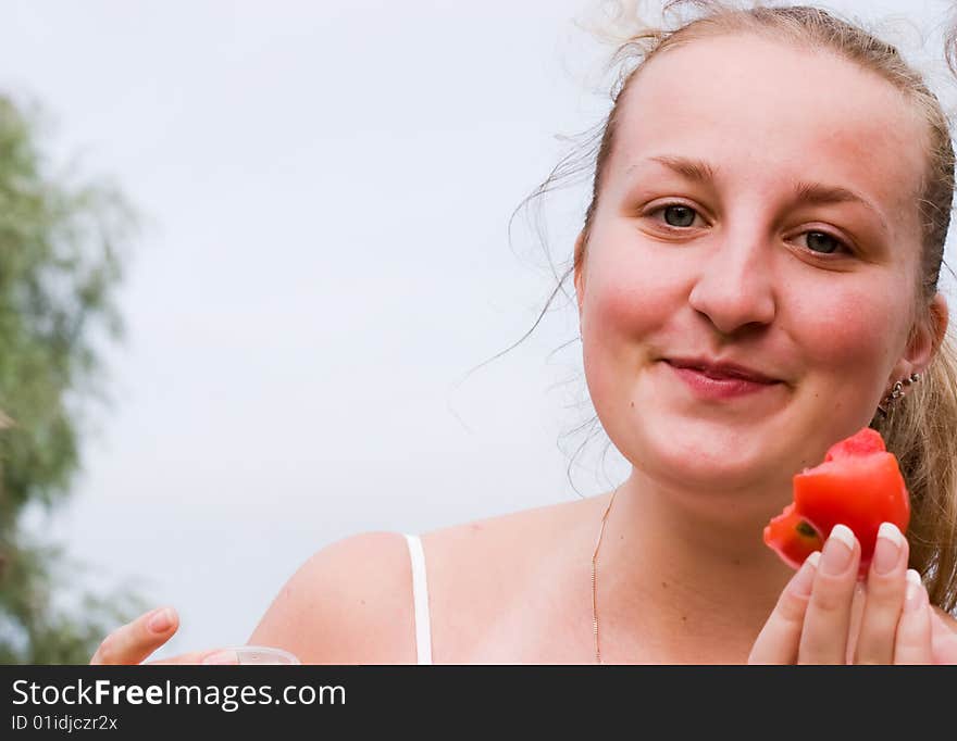 Funny young girl with tomato