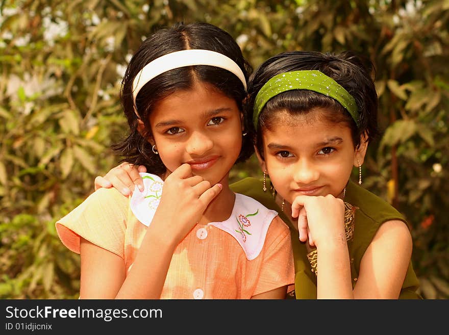 Two bright and beautiful girls actively listening the onlooker. Two bright and beautiful girls actively listening the onlooker.