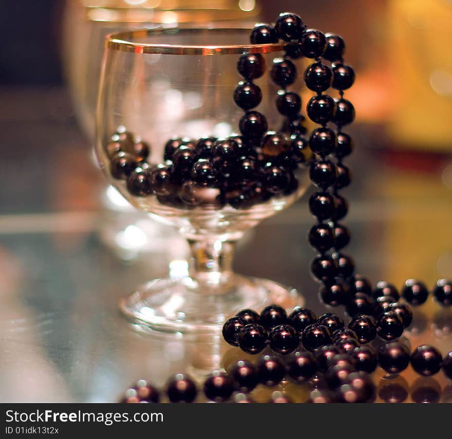 Still life, black beads lie in a stoup, small depth of sharpness. Still life, black beads lie in a stoup, small depth of sharpness