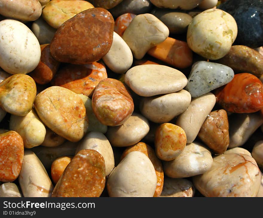 Beautiful decorative background from sea stones covered by  sunlight