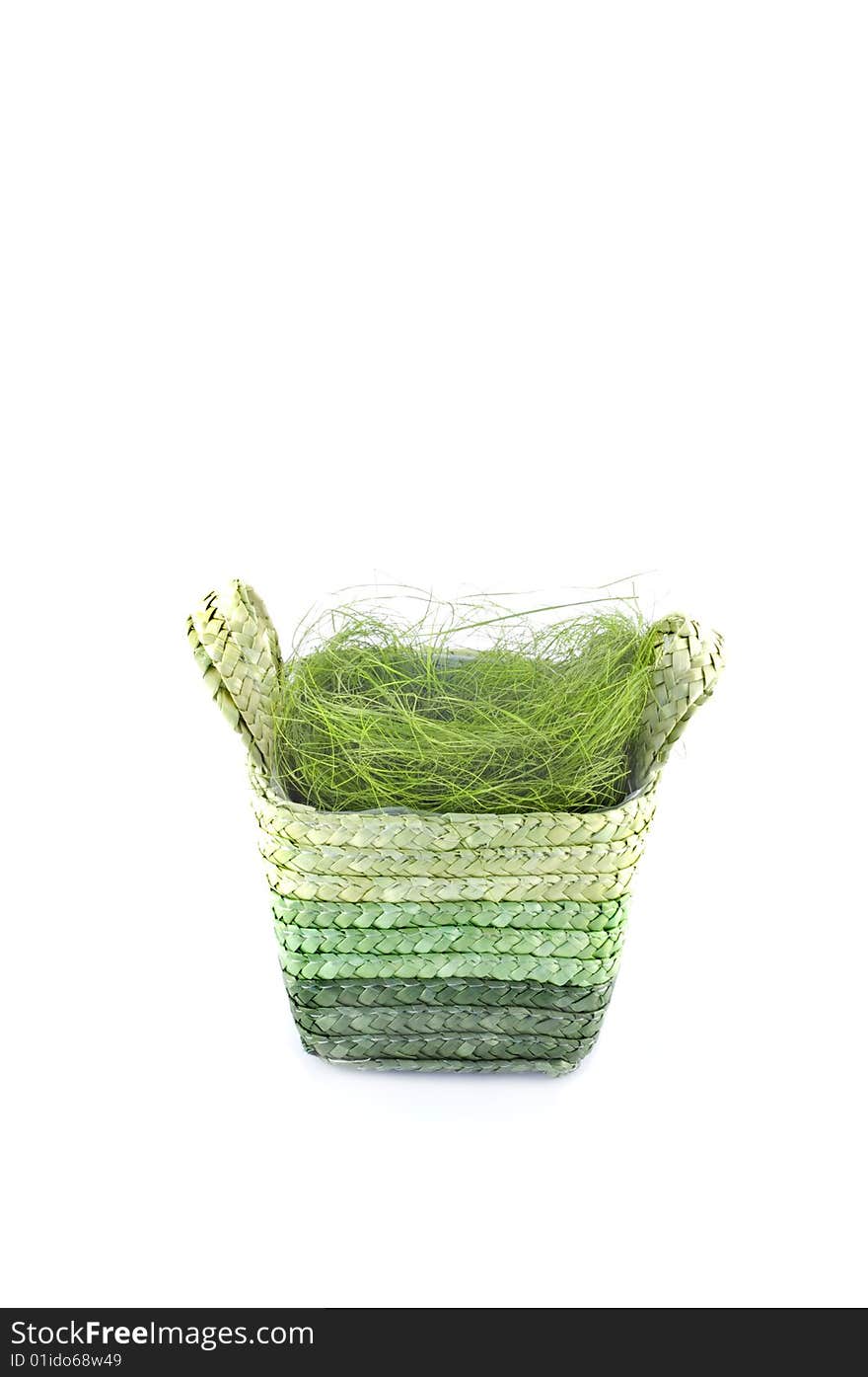 Easter basket with grass isolated on white.Place for text